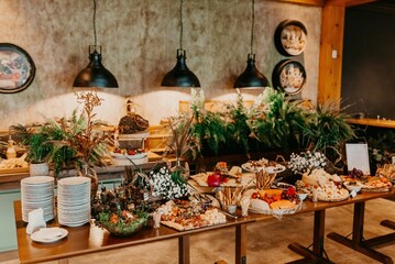 A closeup of a festive table with a variety of sweets and snacks served during the ceremony