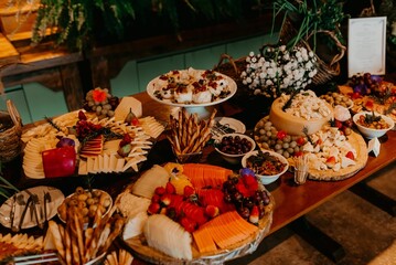 A closeup of a festive table with a variety of sweets and snacks served during the ceremony