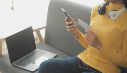 Close up of woman hand using credit card and laptop for payment and online shopping, Online...