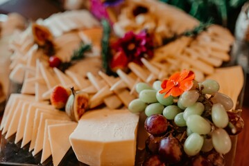 a variety of cheeses and appetizers on a wooden table