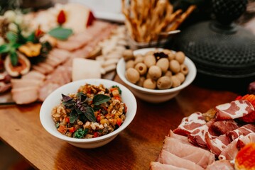 Array of assorted snacks are arranged on a wooden table top