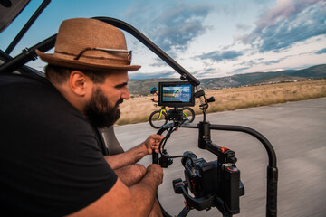 A videographer recording a triathlete riding his bike preparing for an upcoming marathon.Athlete's...