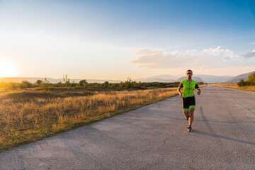 Triathlete in professional gear running early in the morning, preparing for a marathon, dedication to sport and readiness to take on the challenges of a marathon. 