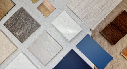samples of material including blue laminated, stone ceramic tiles, grainy quartz, metallic stainless, fabric laminated, wooden engineering floor tile in top view. palette of interior materials.
