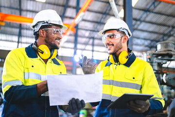 professional technician engineer with safety helmet hard hat working in industrial manufacturing...