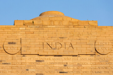 The inscription on the wall of the word India. Arch - India Gate, a monument in Delhi.