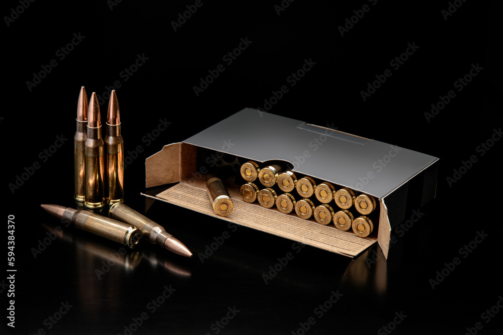 Poster Bullet isolated on black background with reflexion. Rifle bullets close-up on black back. Cartridges for rifle and carbine on a black.