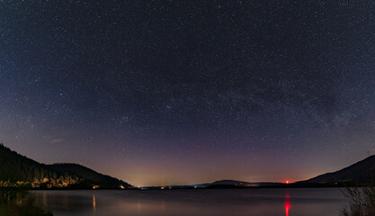 A panoramic night view of the night sky looking over Bassenthwaite lake in the English Lake District. - Powered by Adobe