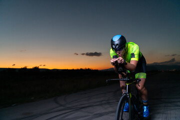 A triathlete rides his bike in the darkness of night, pushing himself to prepare for a marathon....