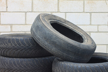 old worn out summer tire next to old winter tire as sample of damaged tires from summer and winter tires