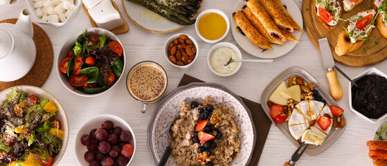 Different tasty food for brunch on white wooden table, flat lay. Banner design