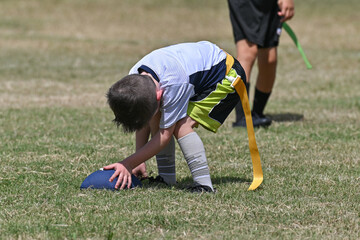 Young athletic children playing in a competitive flag football game