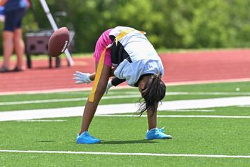 Young athletic children playing in a competitive flag football game