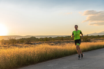 Triathlete in professional gear running early in the morning, preparing for a marathon, dedication to sport and readiness to take on the challenges of a marathon. 