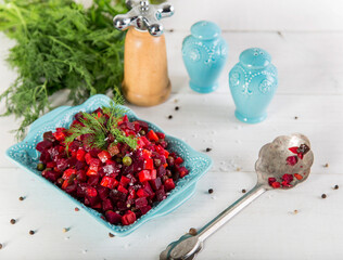 Vinaigrette salad with boiled vegetables, pickled cucumbers, sauerkraut and canned greens isolated on white. Traditional Russian snack. Vegetarian food.