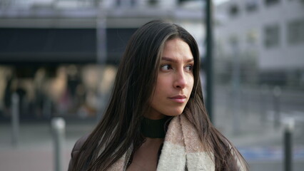 Fototapeta premium Portrait of a Middle Eastern young woman standing in city street with confident expression