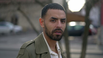 Portrait face of a Middle Eastern young man with serious expression staring at camera