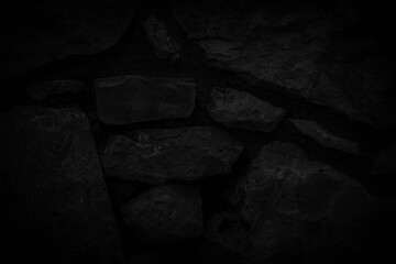 Black abstract background of old stone wall texture