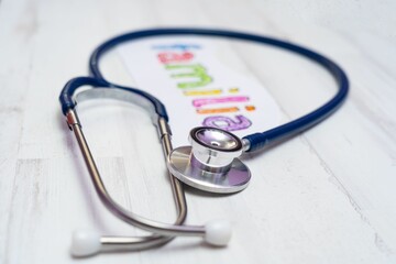 Closeup of a stethoscope and paper with Familia handwritten on it, healthcare concept