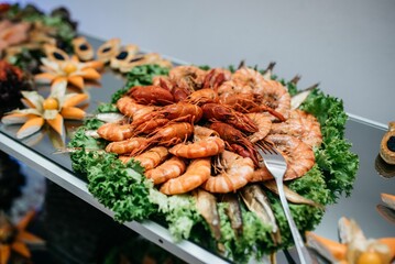 Buffet-style spread featuring a variety of fresh, succulent shrimp, colorful vegetables