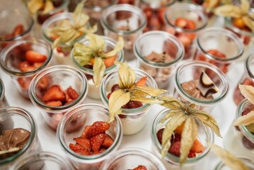 Still-life image of mason jars filled with a variety of fresh fruits and vegetables