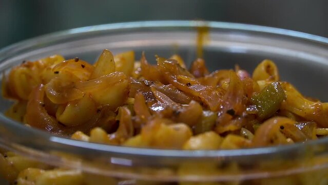 Closeup shot of macrony pasta served in bowl.