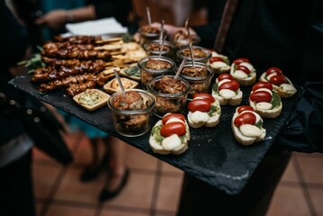 Array of savory appetizers arranged on a platter is presented at a festive event