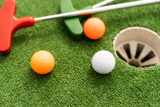 Mini-golf ball on artificial grass. Summer season game