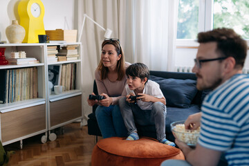 Obraz premium Mother and son play the video game together at home