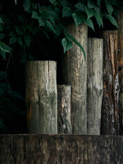 Stacked stumps in the fence next to the tree