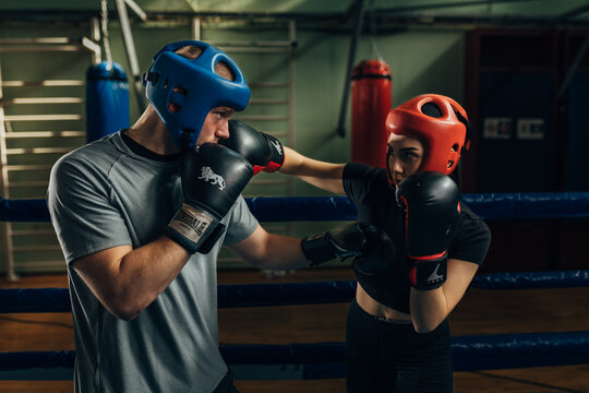 Female and male fighters practice boxing moves together