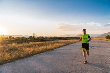 Triathlete in professional gear running early in the morning, preparing for a marathon, dedication to sport and readiness to take on the challenges of a marathon. 