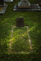 Outdoor graveyard scene featuring numerous tombstones in the background