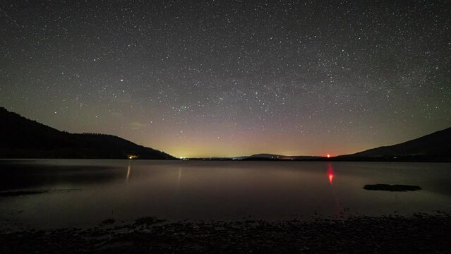 A time-lapse of the night sky over Bassenthwaite lake in the English Lake District with a very faint Aurora.