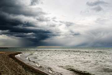 dramatic rain clouds over lake ontario seen from toronto's kew beach on a spring evening