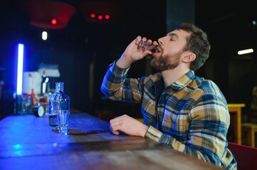 Sad man sitting at bar counter, alcohol addiction