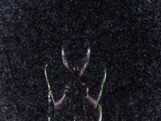 A triathlete braving the rain as he cycles through the night, preparing himself for the upcoming...