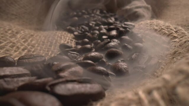 Close up of seeds of coffee. Fragrant coffee beans are roasted smoke. 4K ProRes