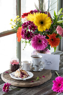 A Mother's Day scene with tea and scones and a beautiful bouquet of flowers.