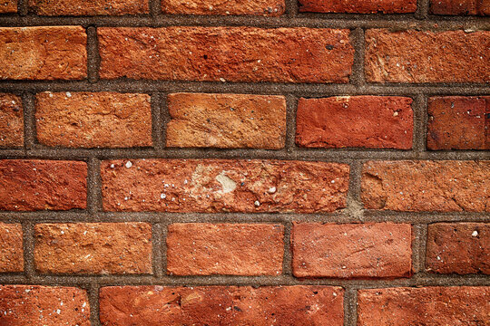 Fototapeta Mur z czerwonej cegły z równych prostokątów. Ściana. 