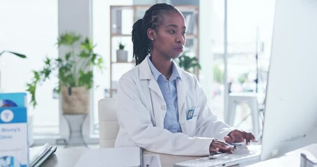 Black woman, doctor and computer for typing, reading or email communication at clinic office. Female african medic, desktop and focus for report, admin or planning at hospital for medical research - Powered by Adobe