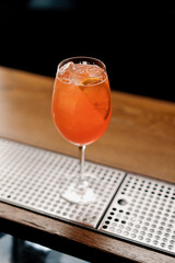 Delicious Aperol spritz cocktail standing on bar counter in restaurant bar waiting for waiter and...
