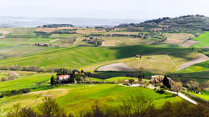 Green fields springtime landscape panoramic view in Tuscany, Italy