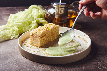 Piece of cake Napoleon puff pastry with custard cream. Russian cuisine, multi layered cake with...