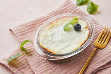 Delicious cottage cheese casserole in portioned glass forms with sour cream. Traditional Russian cuisine for breakfast - Zapekanka.