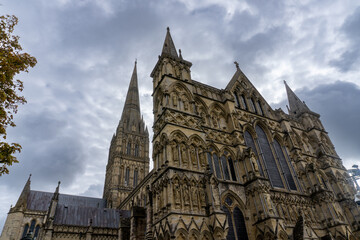 Western front of Salisbury Cathedral in England. Statues of angels, Old Testament patriarchs, apostles, evangelists, martyrs, doctors, philosophers, royalty, priests and worthy people. Tallest spire. 