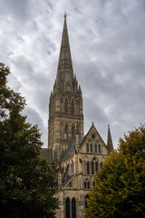 Fototapeta na wymiar Salisbury Cathedral exterior with tallest church spire in United Kingdom. Early English Gothic structure with clerestory windows and North transept.