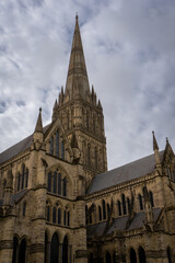 Fototapeta na wymiar Salisbury Cathedral exterior with tallest church spire in United Kingdom. Early English Gothic structure with clerestory windows and North transept.