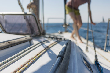 Sailboat yacht sailing in the sea at blue summer sky