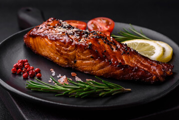 Delicious grilled red salmon fish with sauce, sesame seeds, spices and herbs